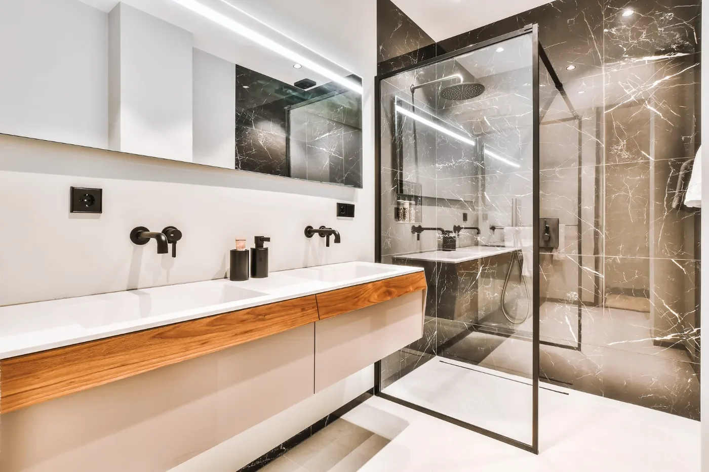 Contemporary bathroom featuring a glass shower enclosure and dual sink vanity with wooden accents. - Gold Remodeling Bellevue, WA