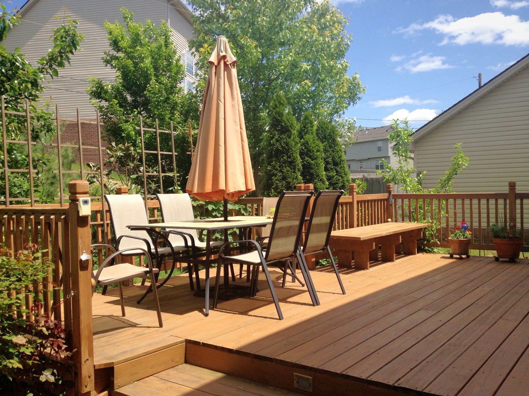 Backyard wood deck arranged for outdoor dining