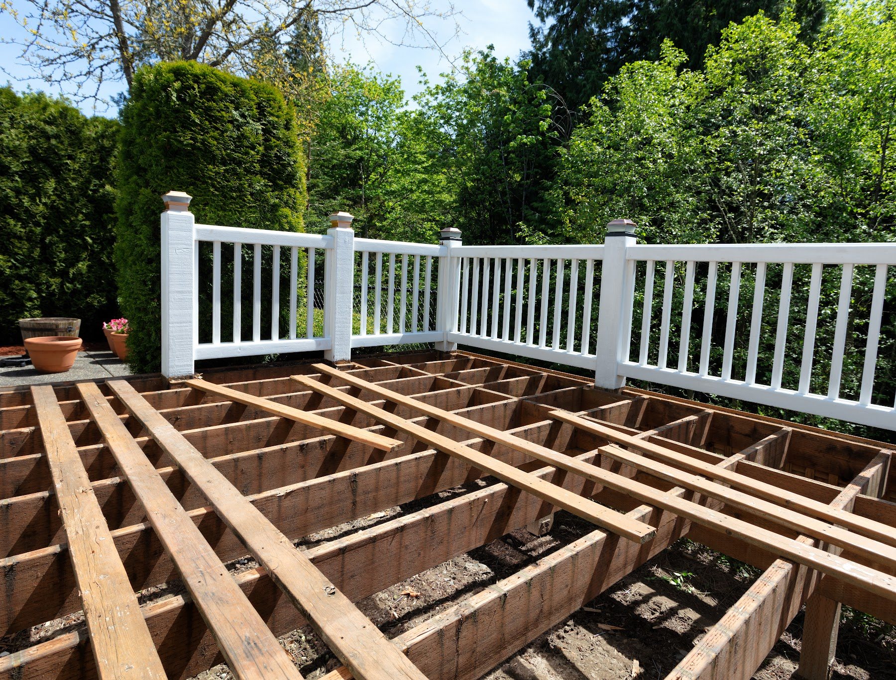 Deck repair project with railing retained and old boards removed