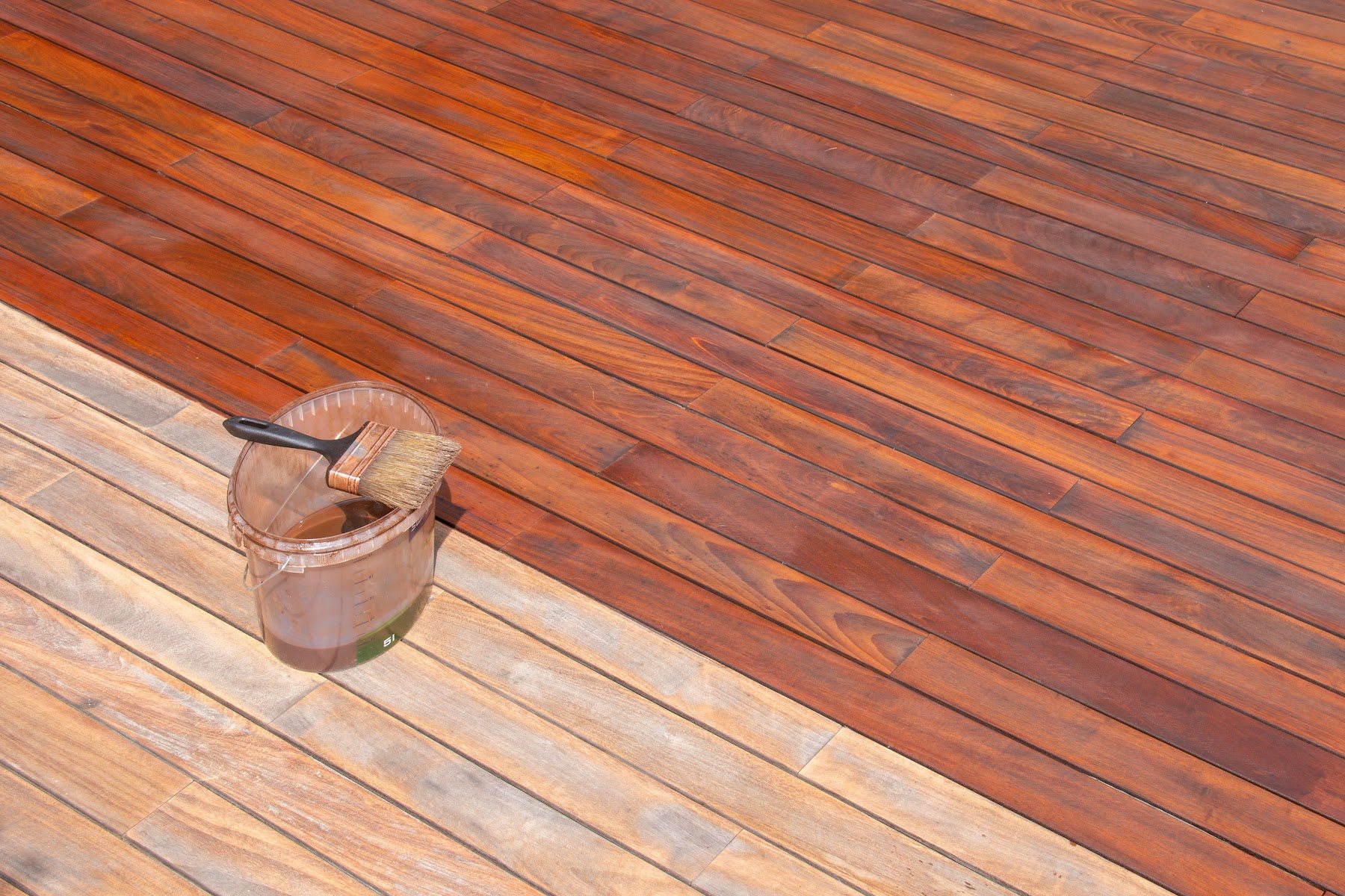 Wood deck showing a clear before-and-after restoration area