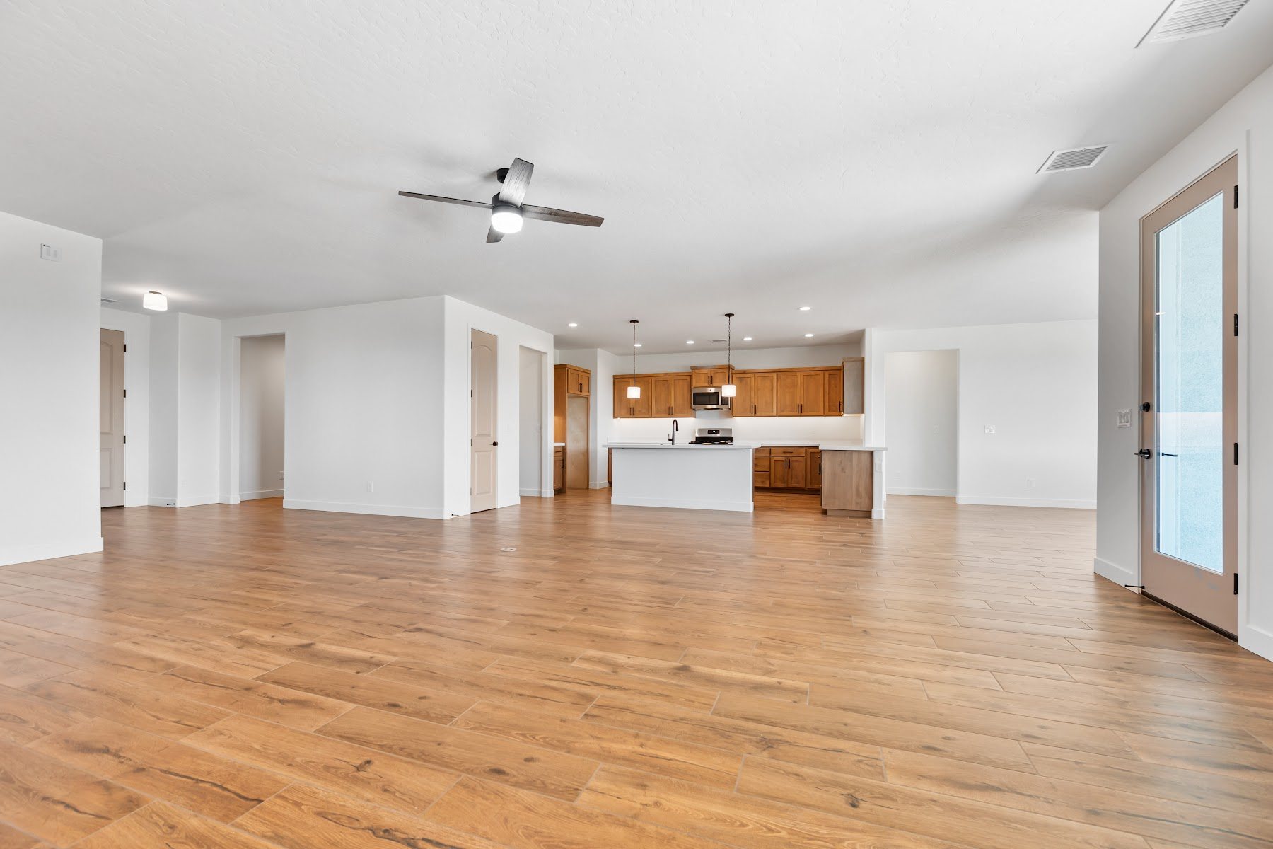 Natural wood flooring across a bright open living space