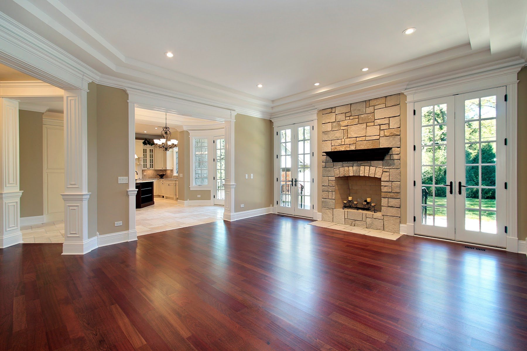 Dark hardwood flooring in a living room with stone fireplace