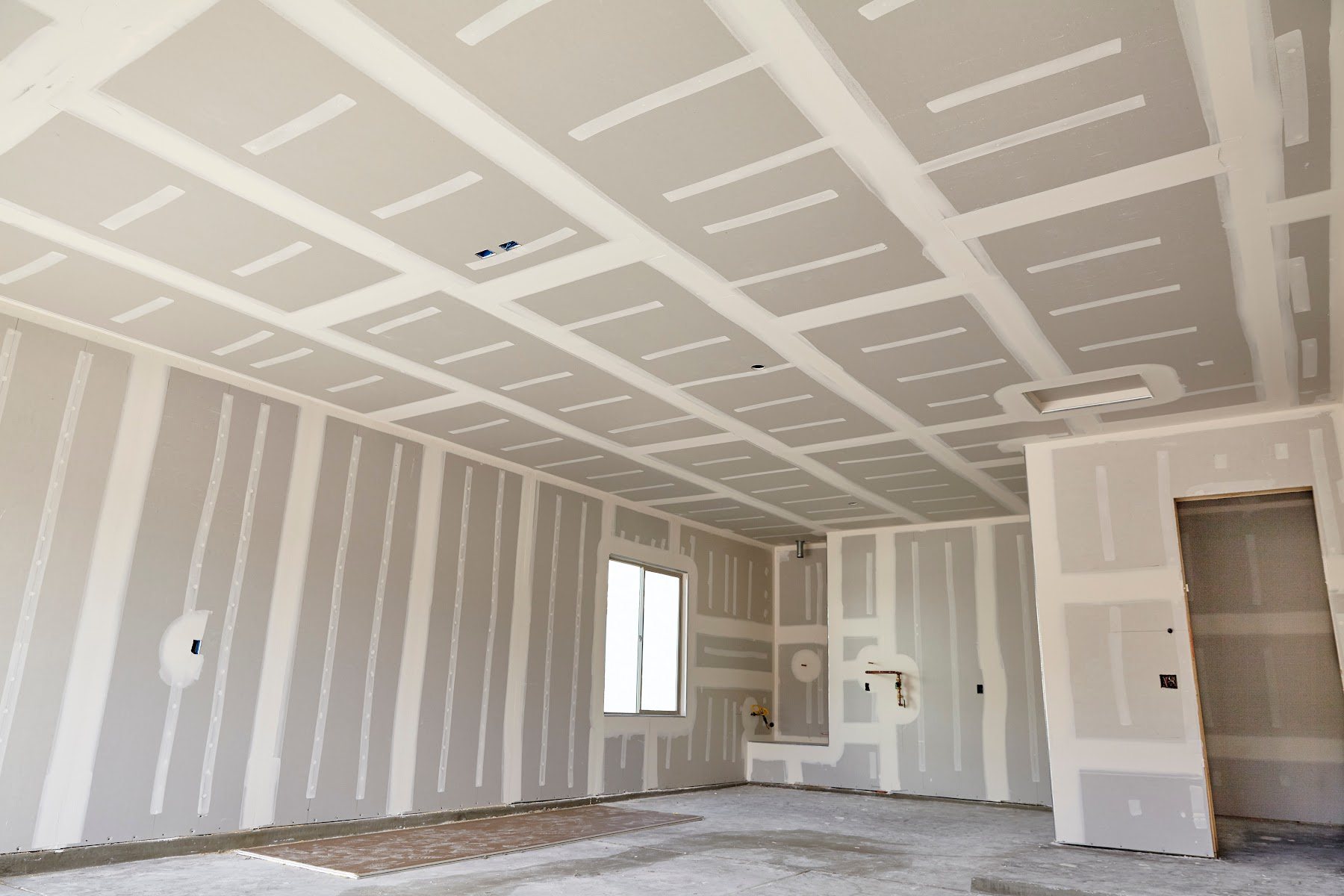 Interior walls and ceiling prepared with fresh drywall finish