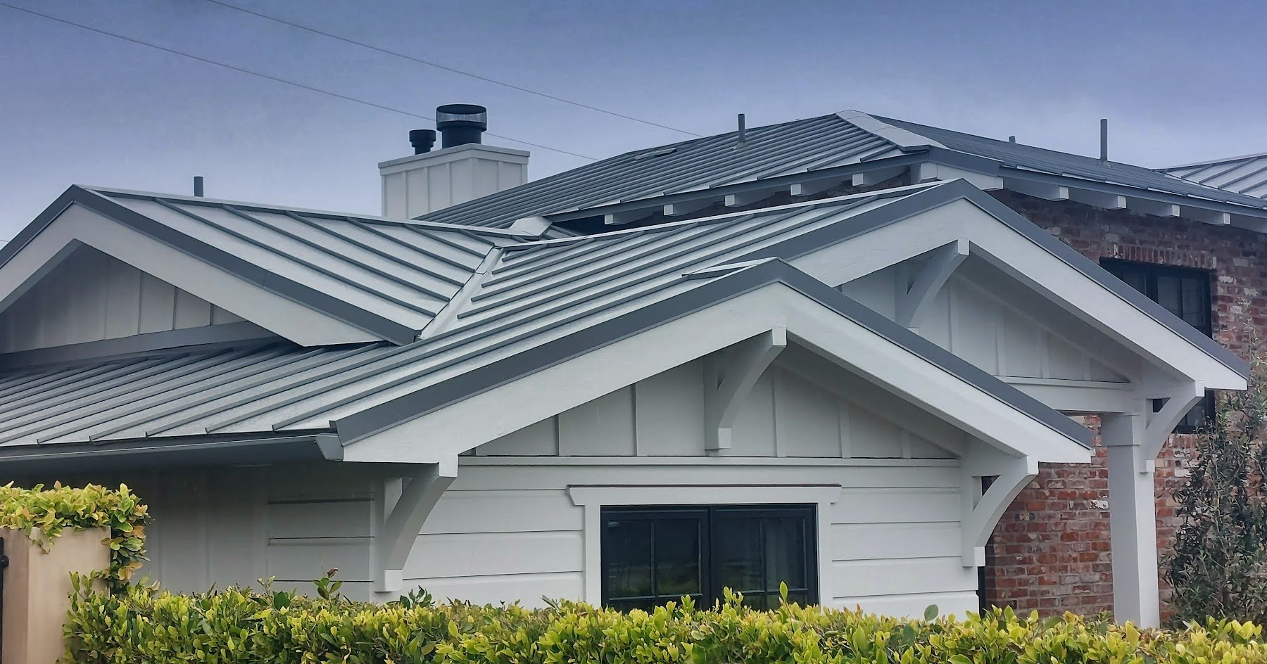 Residential gable roof with gray standing-seam metal panels