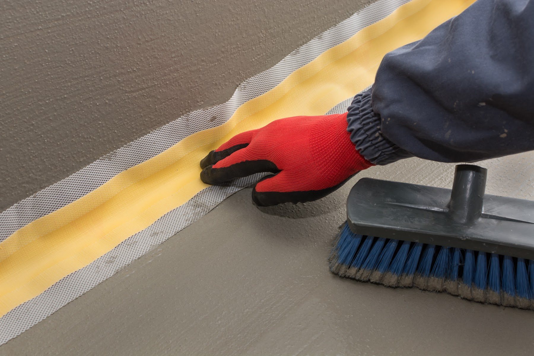 Waterproofing membrane seam being sealed by hand
