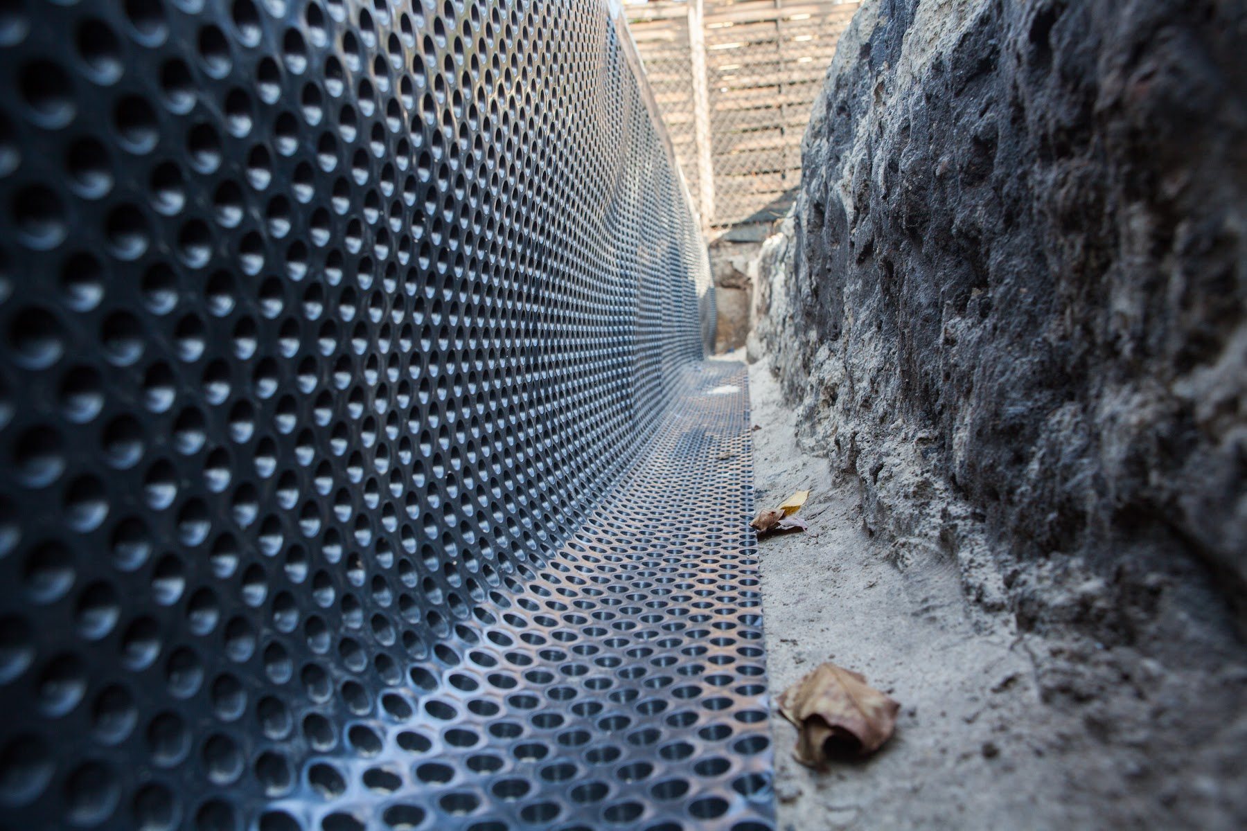 Dimple drainage membrane installed against a foundation wall