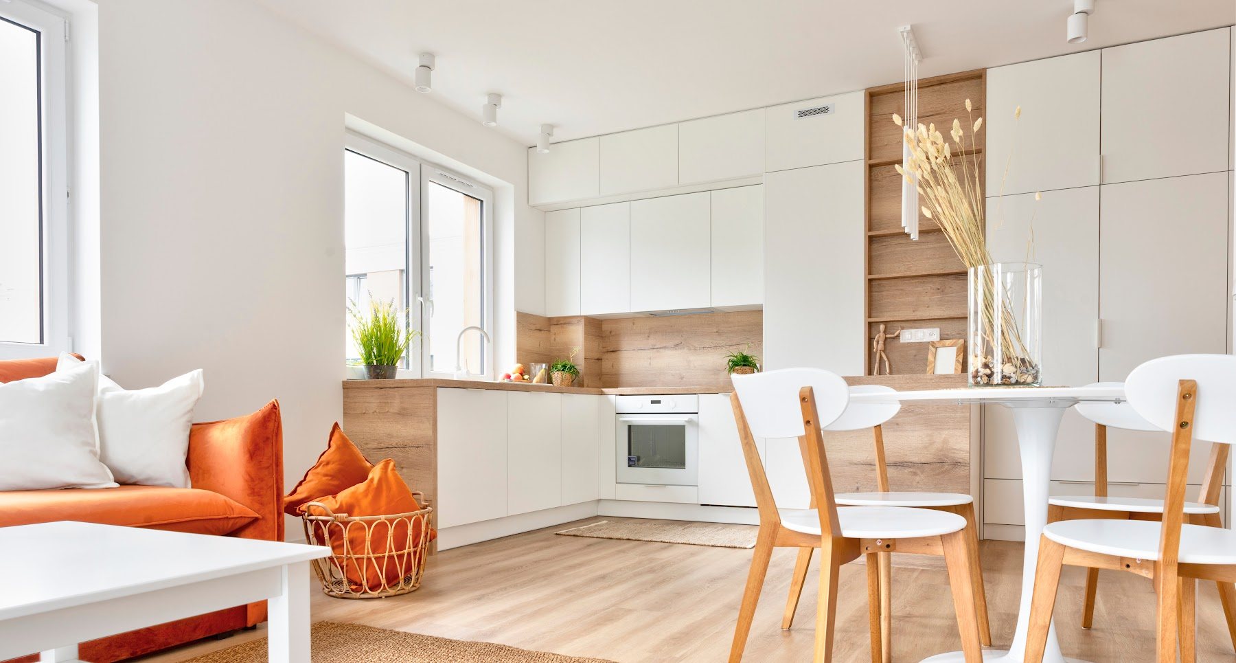 Remodeled dining and living area with light wood floors