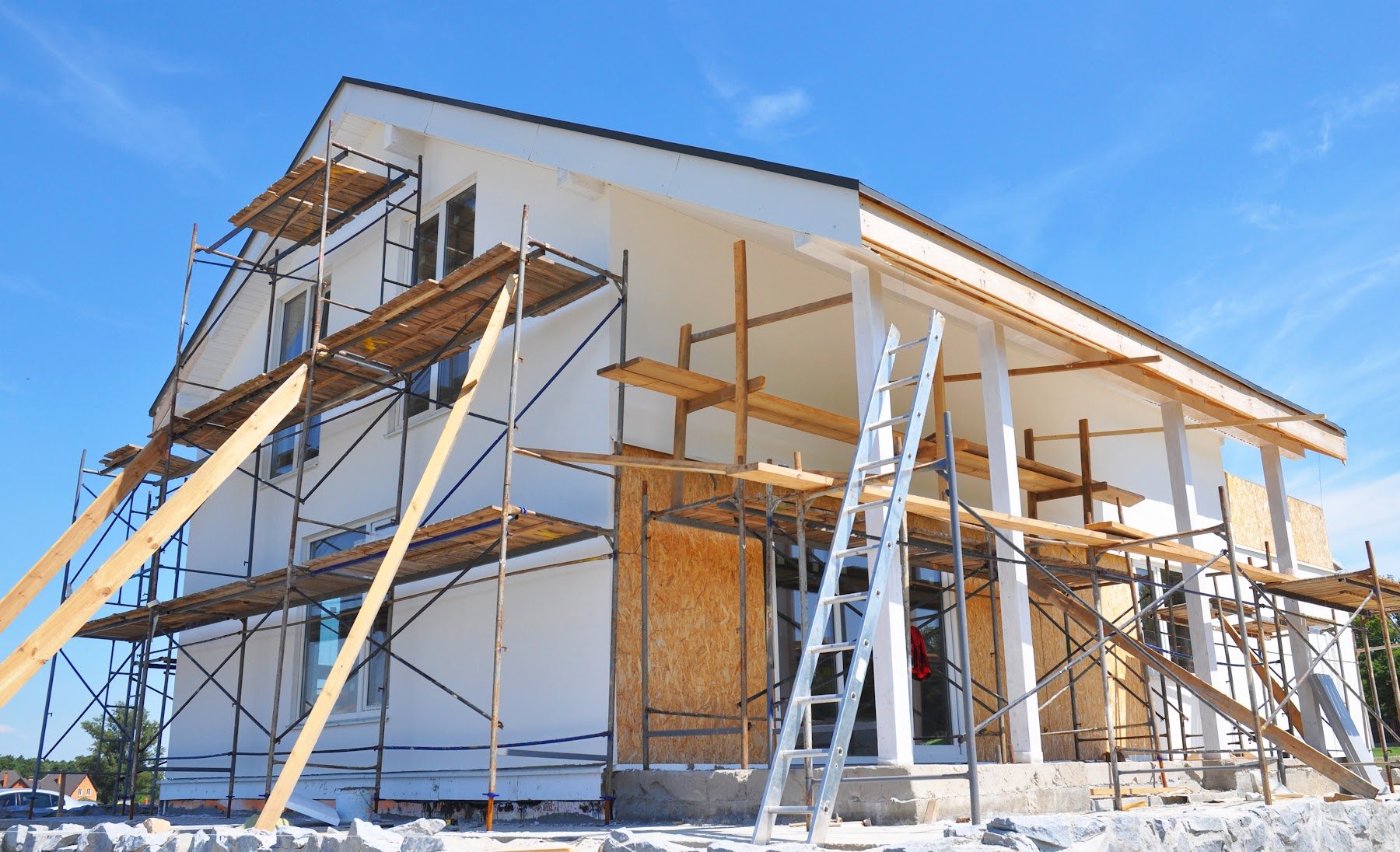 Residential exterior renovation in progress with scaffolding