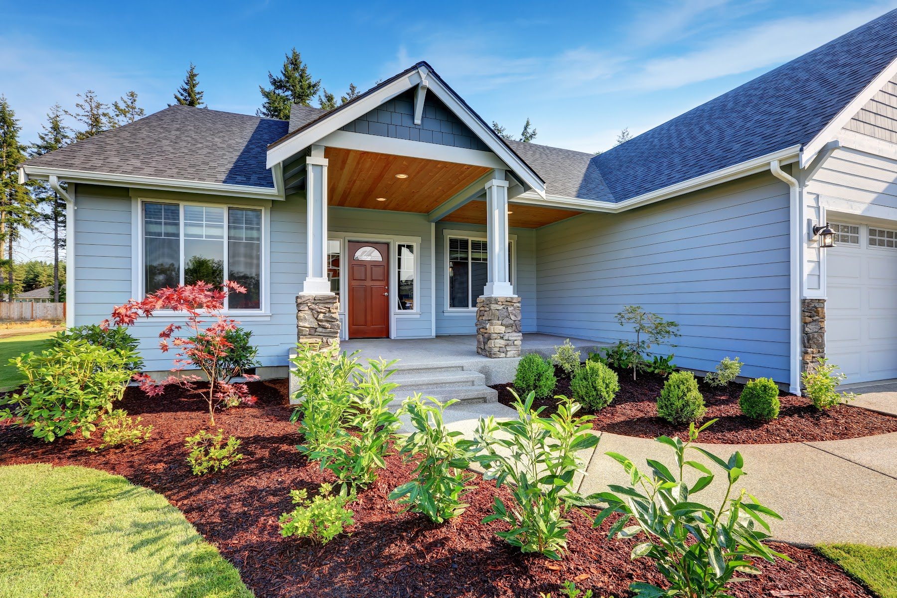 Craftsman-style home with blue-gray siding and wood entry details