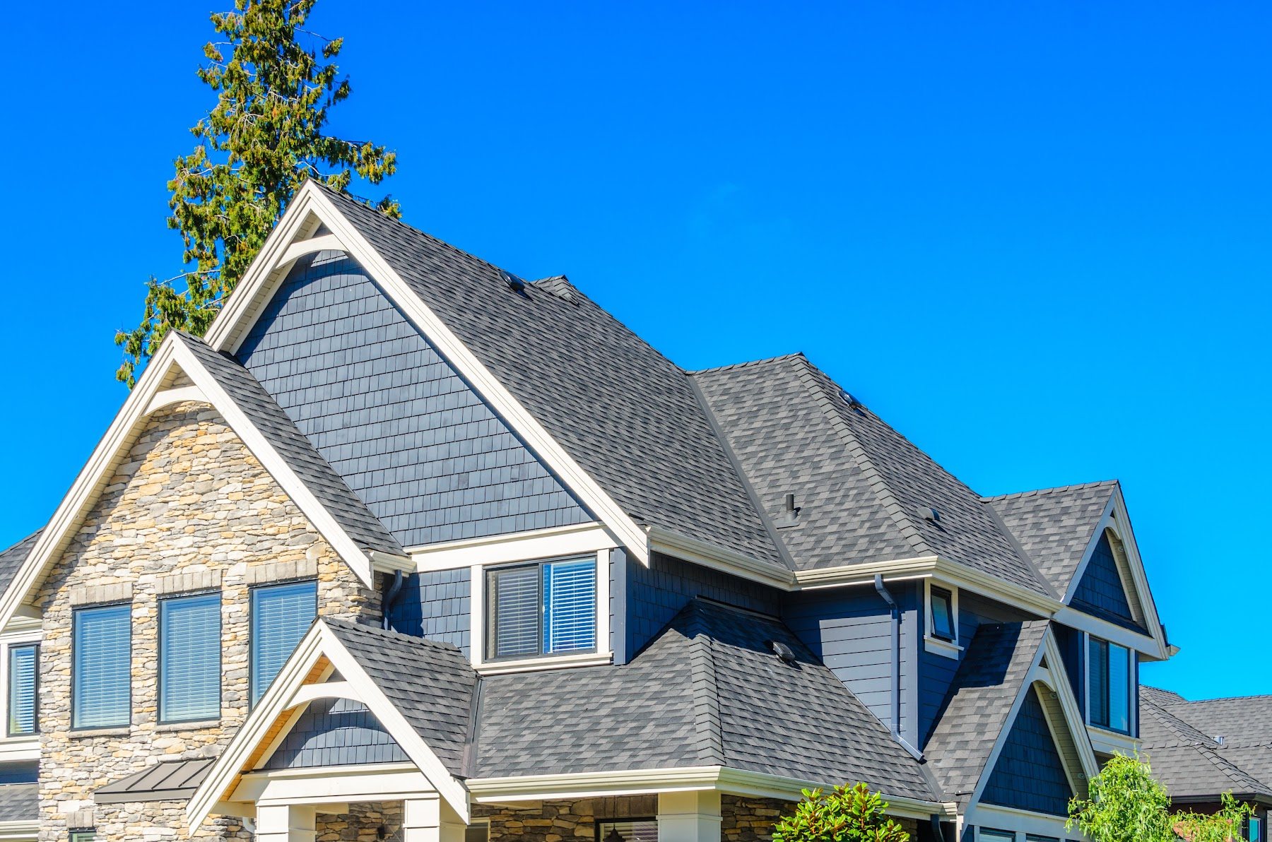 Residential exterior with blue-gray siding and contrasting white trim